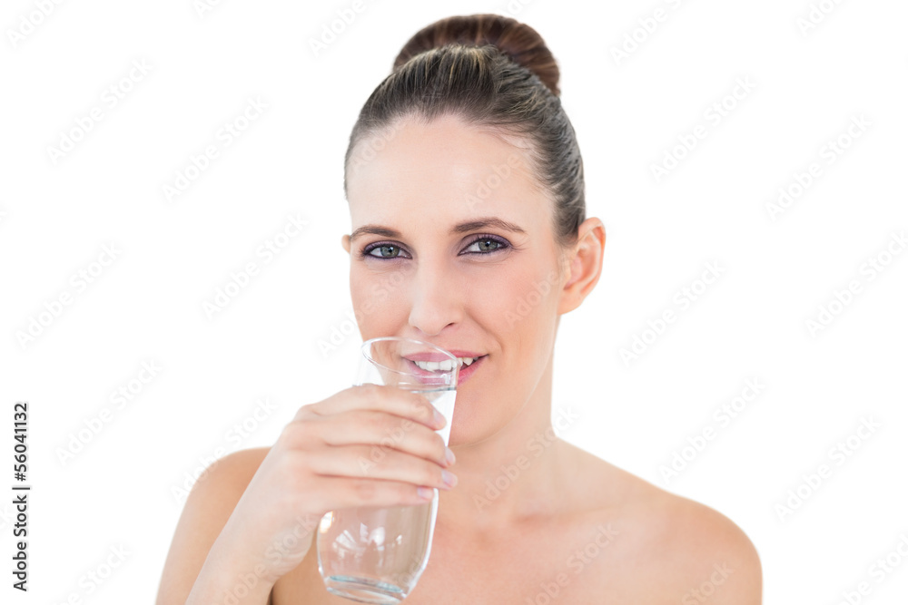 Woman drinking water looking at camera Woman drinking water looking at camera