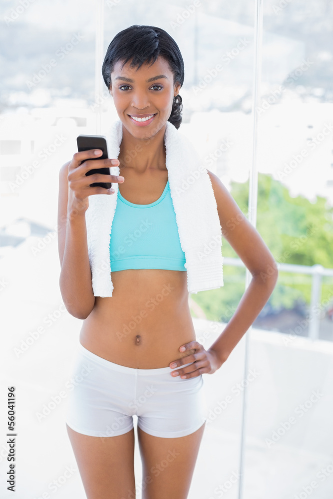 Content black haired woman holding a mobile phone