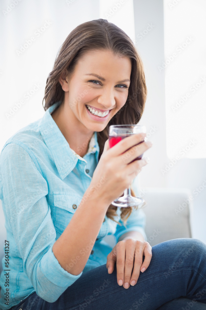 Happy gorgeous brunette holding glass of red wine Happy gorgeous brunette holding glass of red wine
