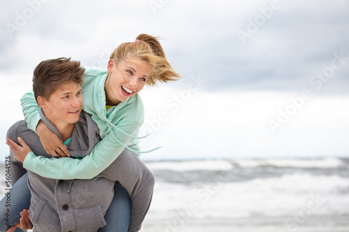 Couple embracing and having fun wearing warm clothes outside on
