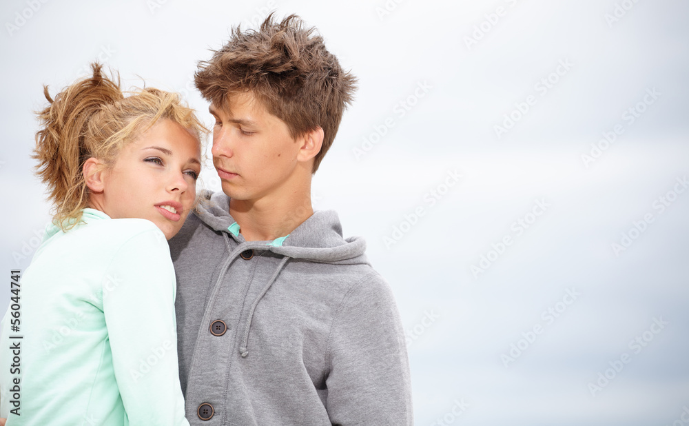 Couple embracing and having fun wearing warm clothes outside on Couple embracing and having fun wearing warm clothes outside on
