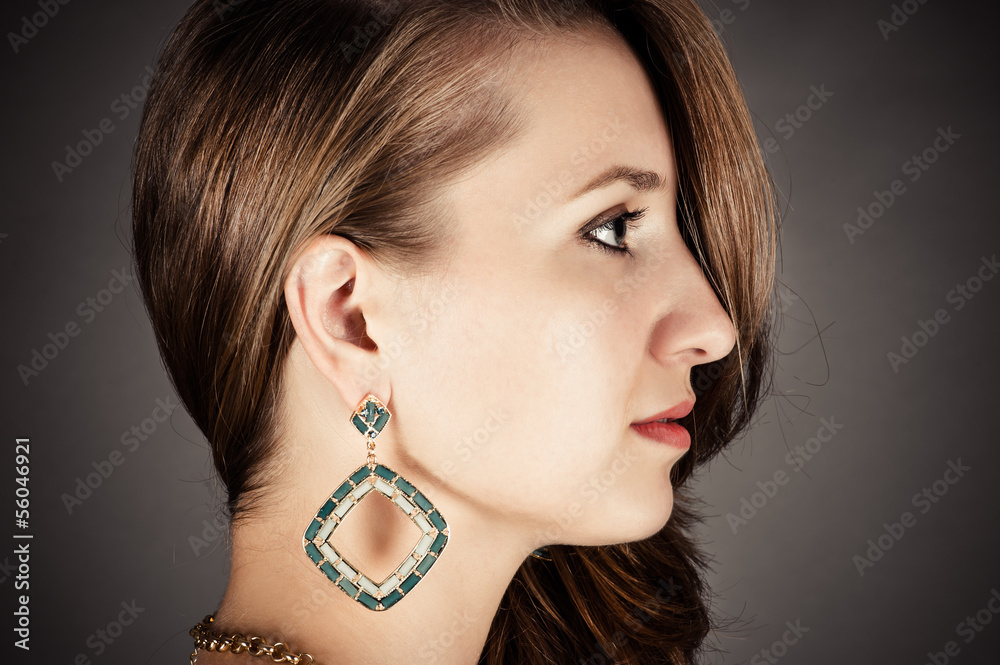 profile of beautiful woman with pierced ears