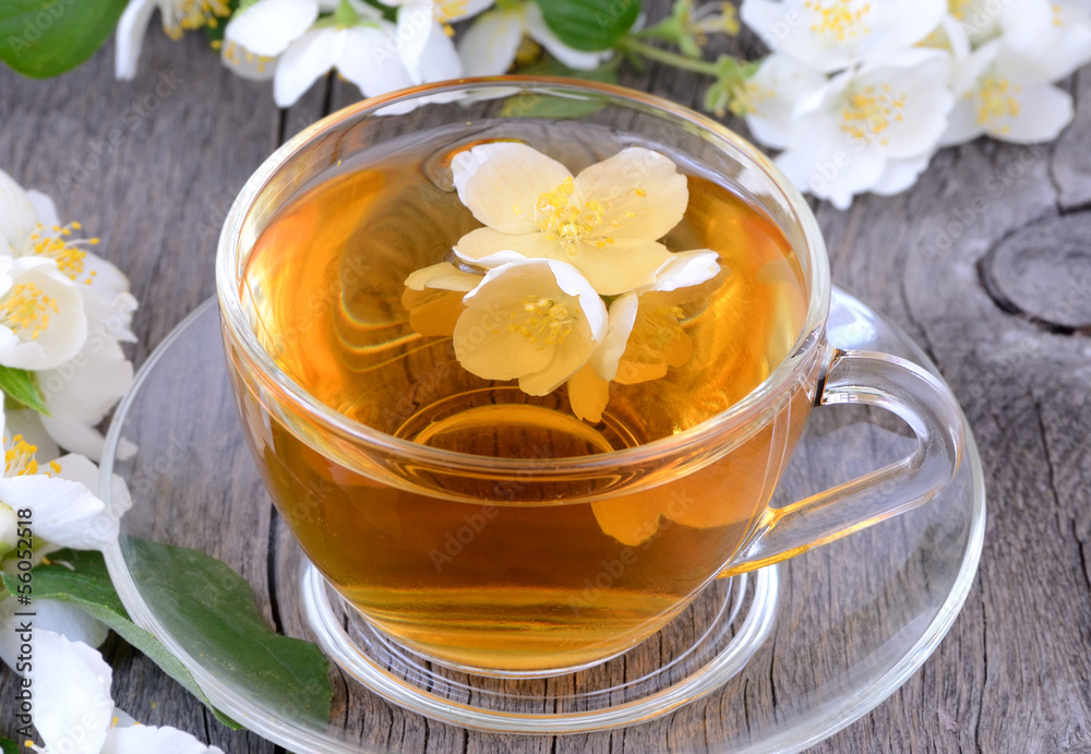 Cup of herbal tea with jasmine flowers Cup of herbal tea with jasmine flowers