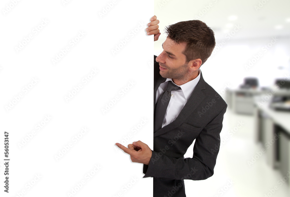 Businessman pointing at a blank board Businessman pointing at a blank board