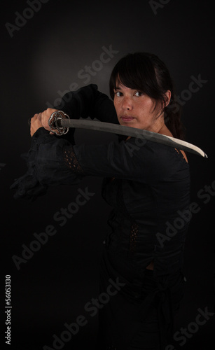 Asian woman holding her sword