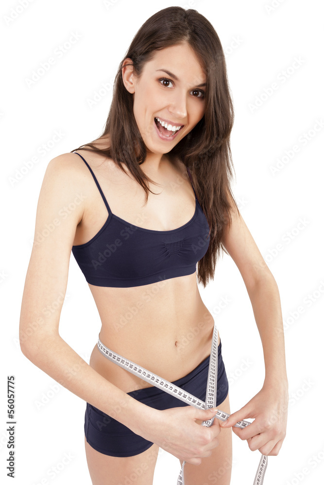 Fototapeta premium young woman measuring her waist and being happy