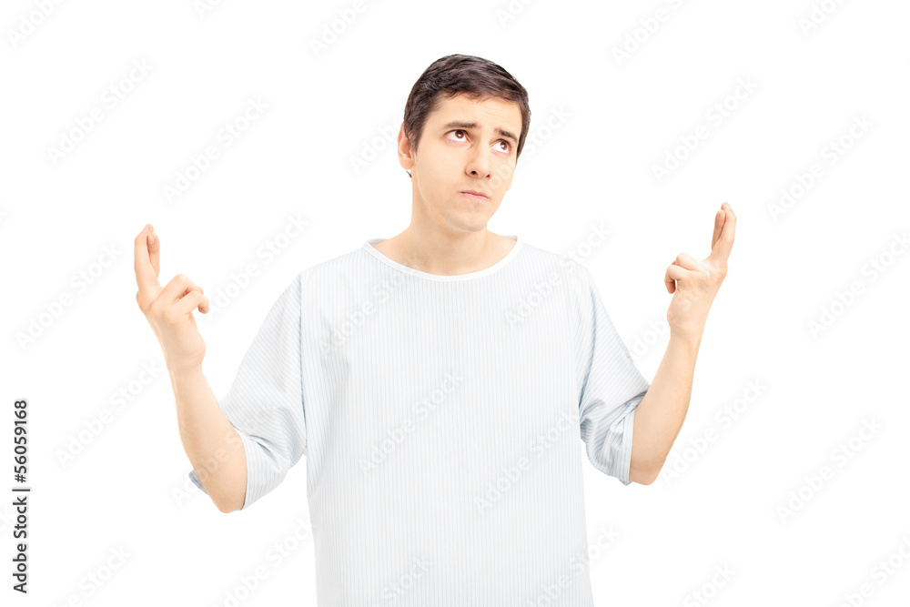 Male patient with fingers crossed looking upwards Male patient with fingers crossed looking upwards