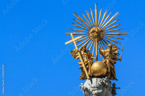 Golden trinity top of a pest column photo