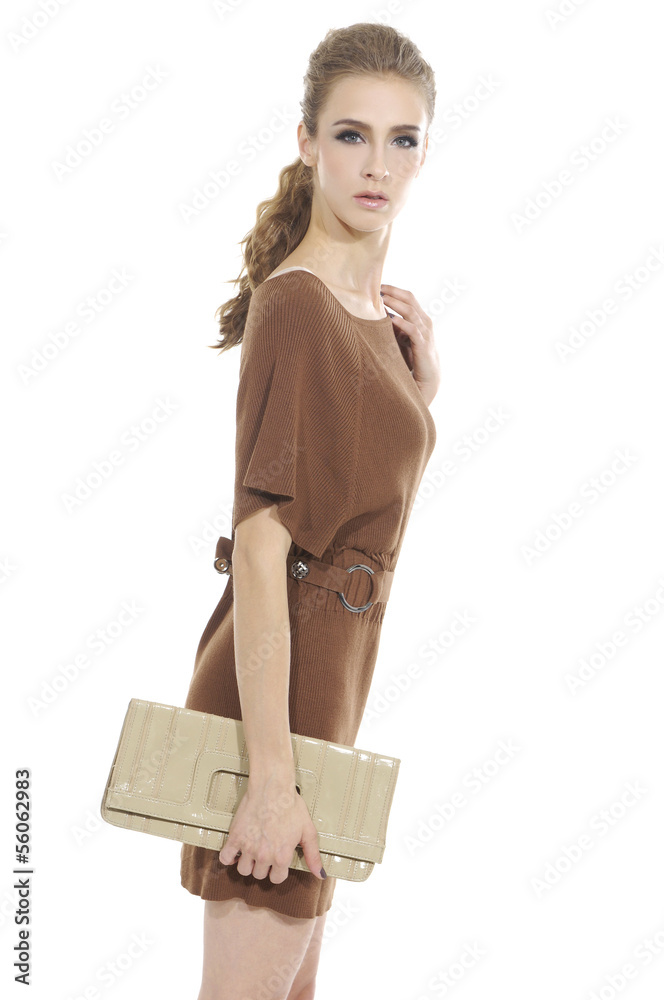 Beautiful casual young woman holding purse standing isolated Beautiful casual young woman holding purse standing isolated