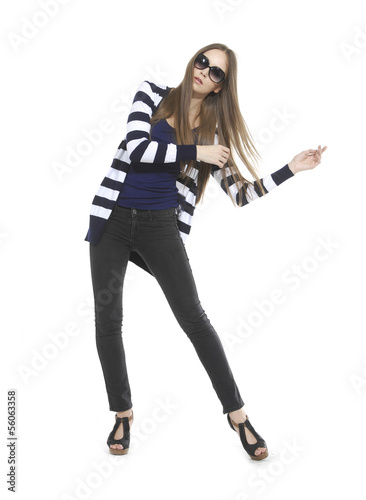 Pretty young woman in stripy shirt and jeans posing