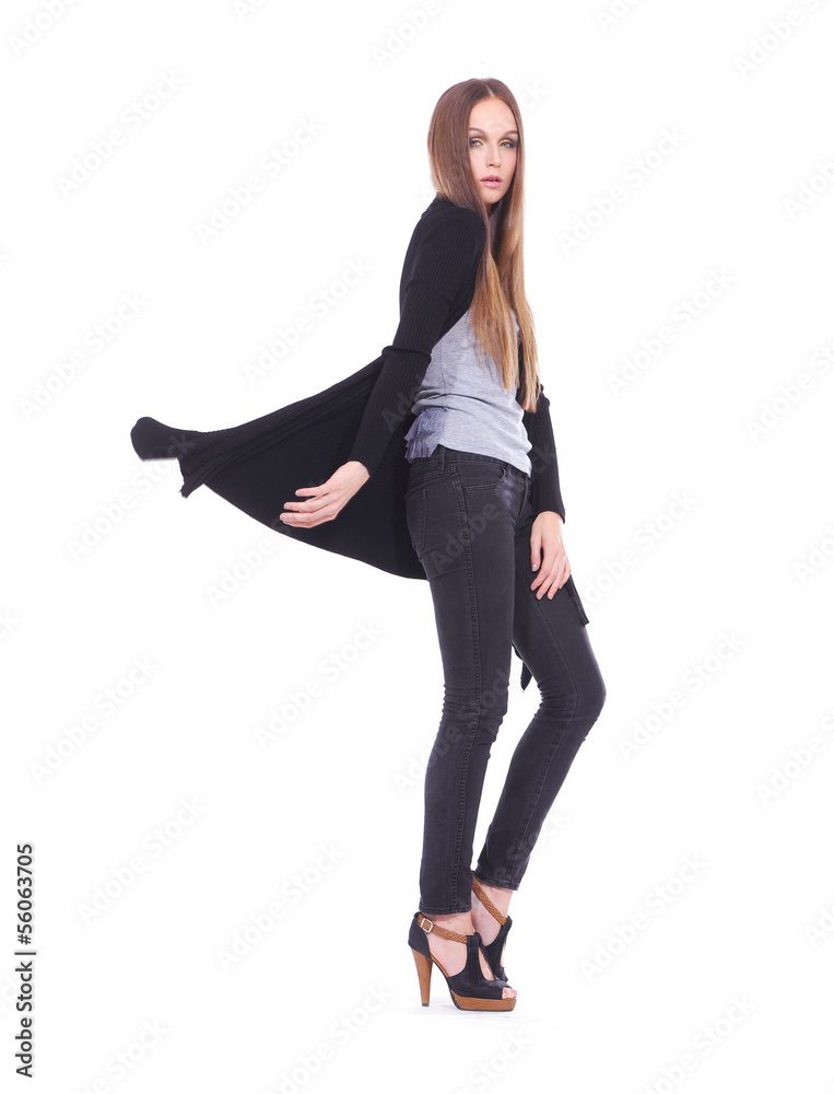 Full length The young long-haired girl posing in studio