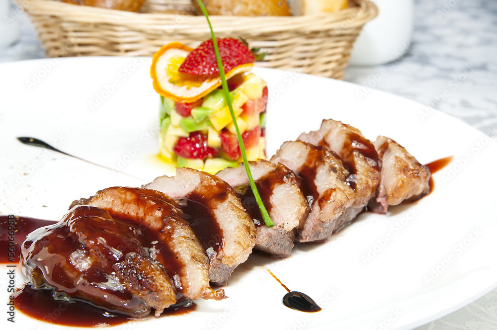 chicken breast with vegetables on a white plate