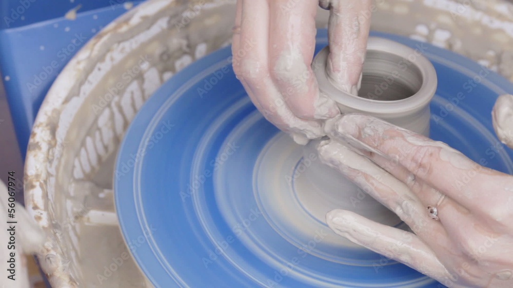 Pottery class workshop. Clay shaping on potter's wheel.