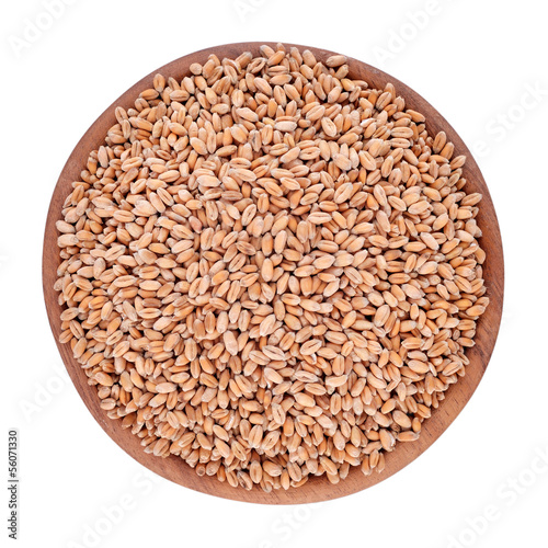 Wheat grains in a wooden bowl on a white background