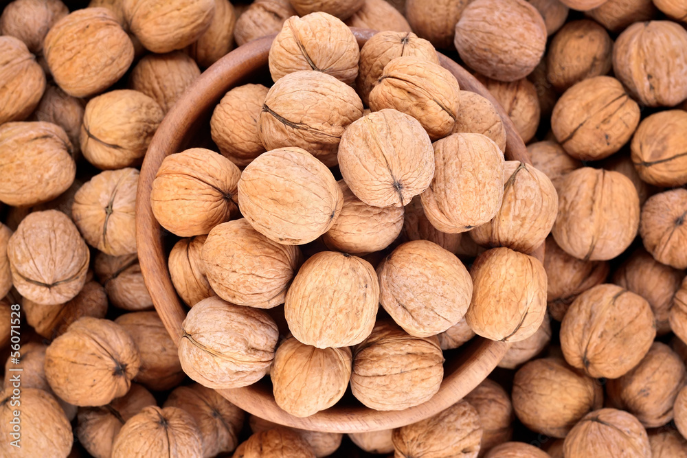 Whole walnuts in a wooden bowl Whole walnuts in a wooden bowl