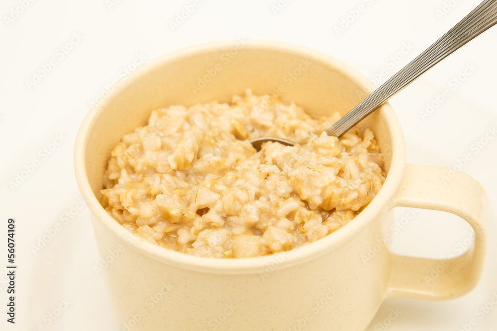 Fresh Hot Oatmeal in a Mug with Spoon Fresh Hot Oatmeal in a Mug with Spoon