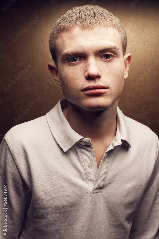 Fototapeta premium Portrait of a handsome red-haired teenager boy with cute flecks