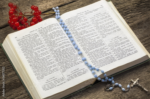 Bible with rosary on boards