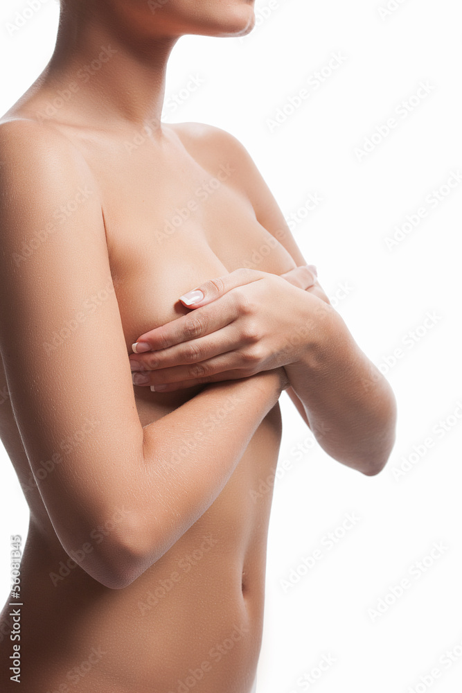 Obraz premium Naked woman. Cropped image of naked woman covering breast with h