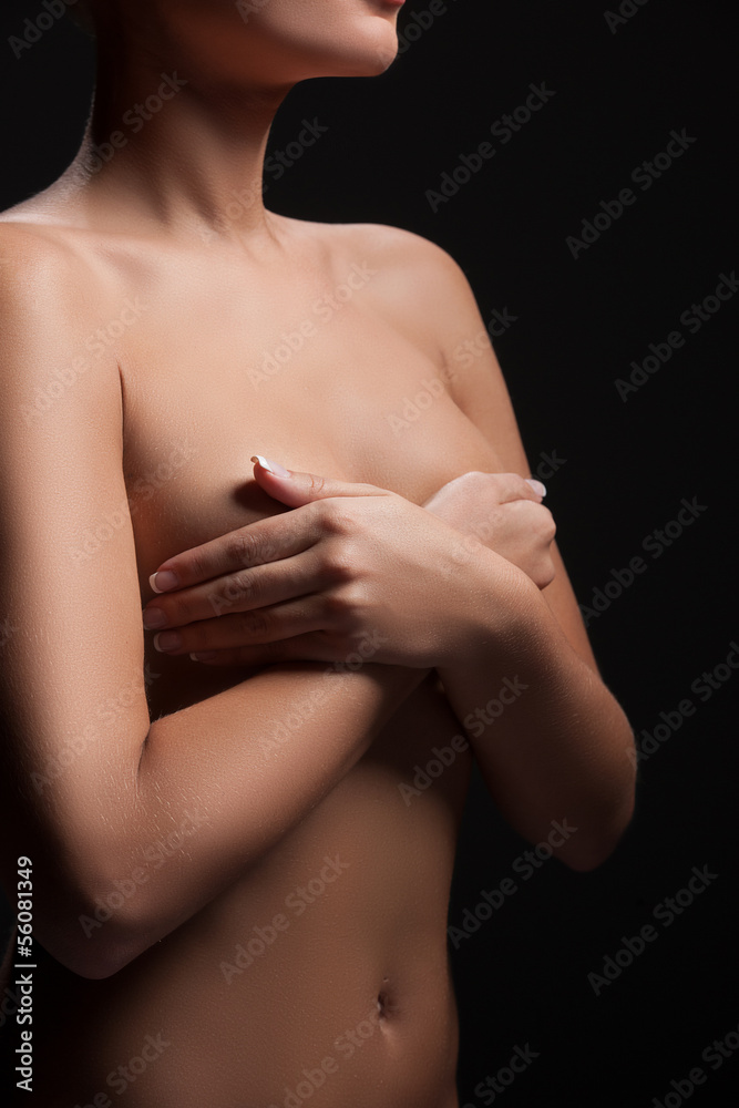 Naked woman. Cropped image of naked woman covering breast with h Naked woman. Cropped image of naked woman covering breast with h