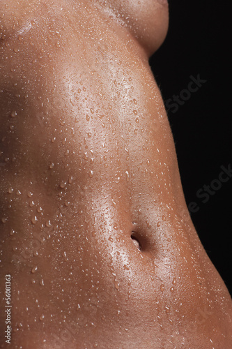 Naked and wet. Close-up of beautiful naked and wet female body i