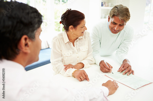 Indian Couple Meeting With Financial Advisor At Home