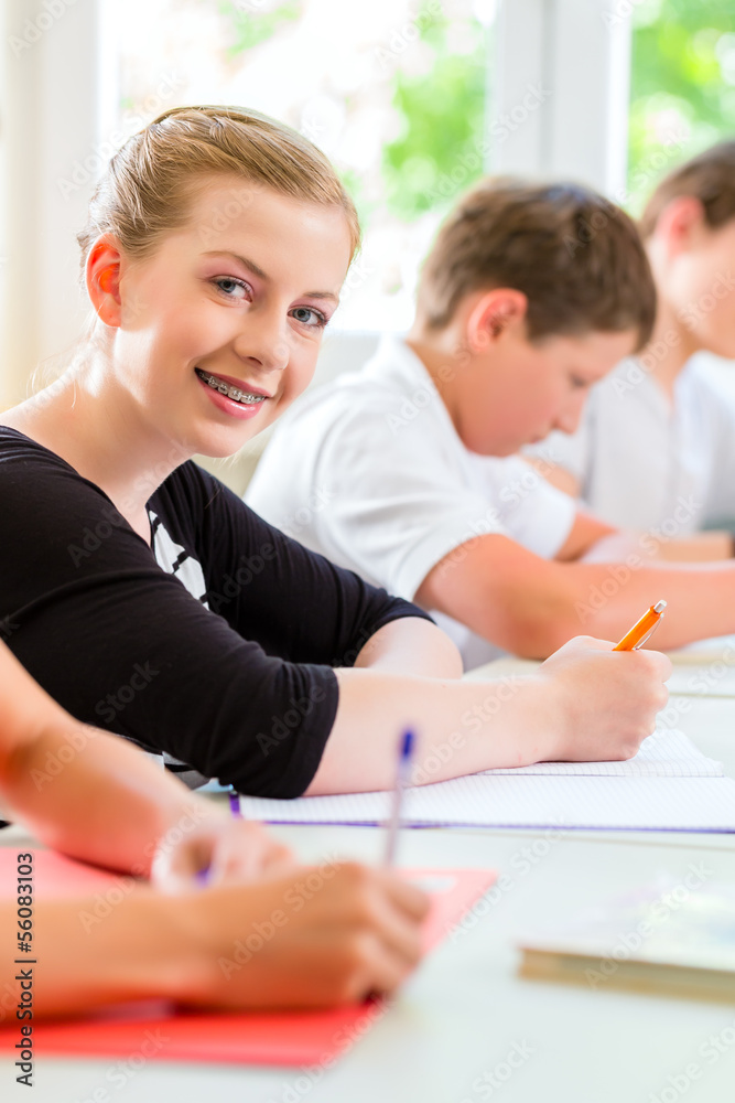 Students writing a test in school concentrating Students writing a test in school concentrating
