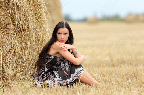 portrait of a girl in a field with hay