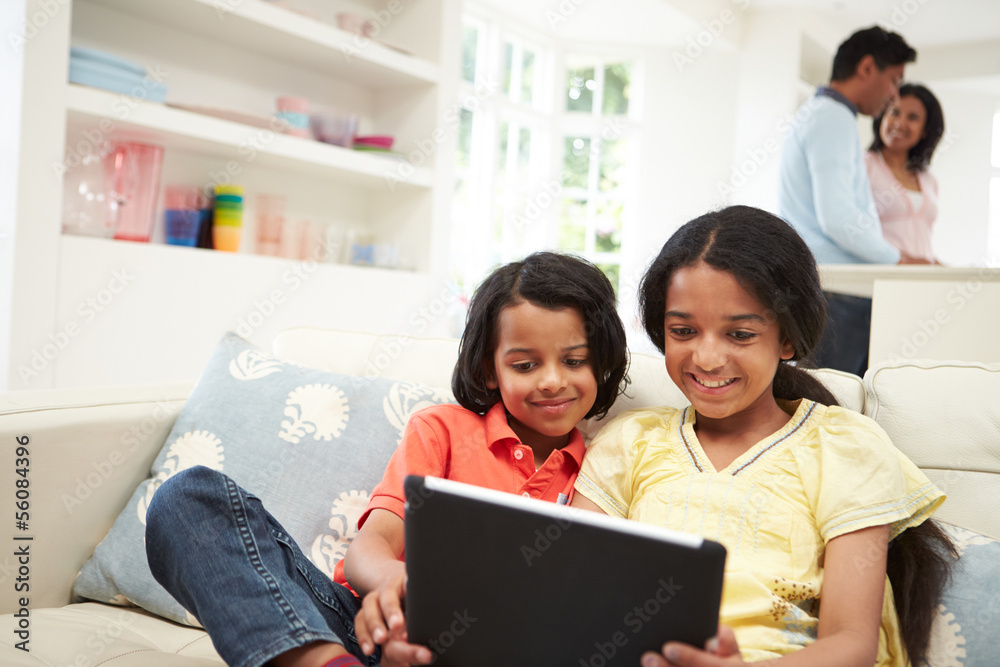 Indian Family With Digital Tablet At Home Indian Family With Digital Tablet At Home