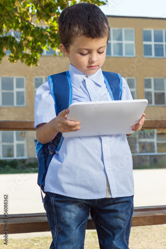 Little boy on his first day at school with tablet