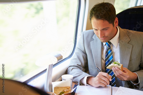 Businessman Eating Sandwich On Train Journey photo