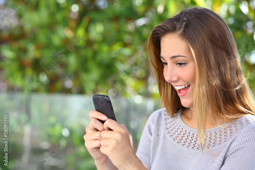 Beautiful woman browsing internet happy in her smart phone