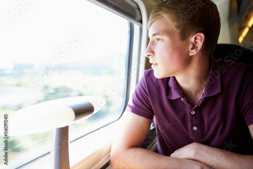 Young Man Relaxing On Train Journey
