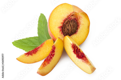 Fresh peach fruits with cut and green leaves on white background