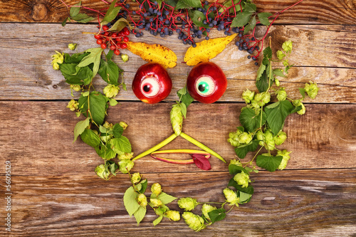 Face out of fruits and plants