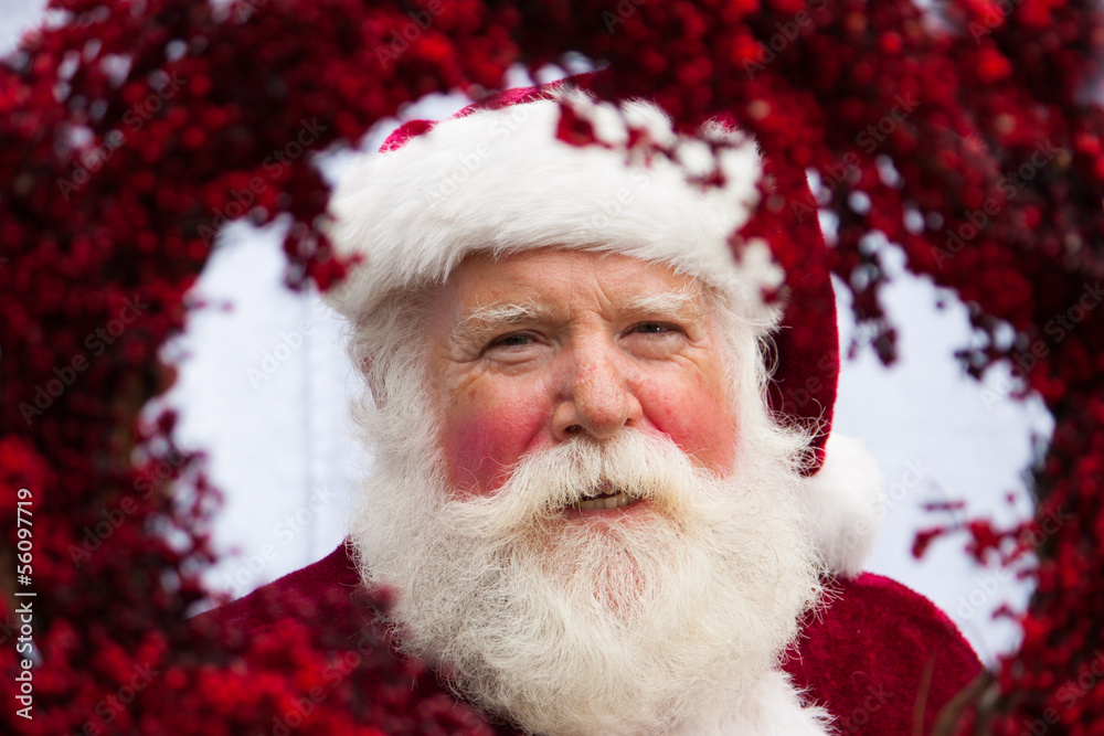 Santa looking through red wreath Santa looking through red wreath