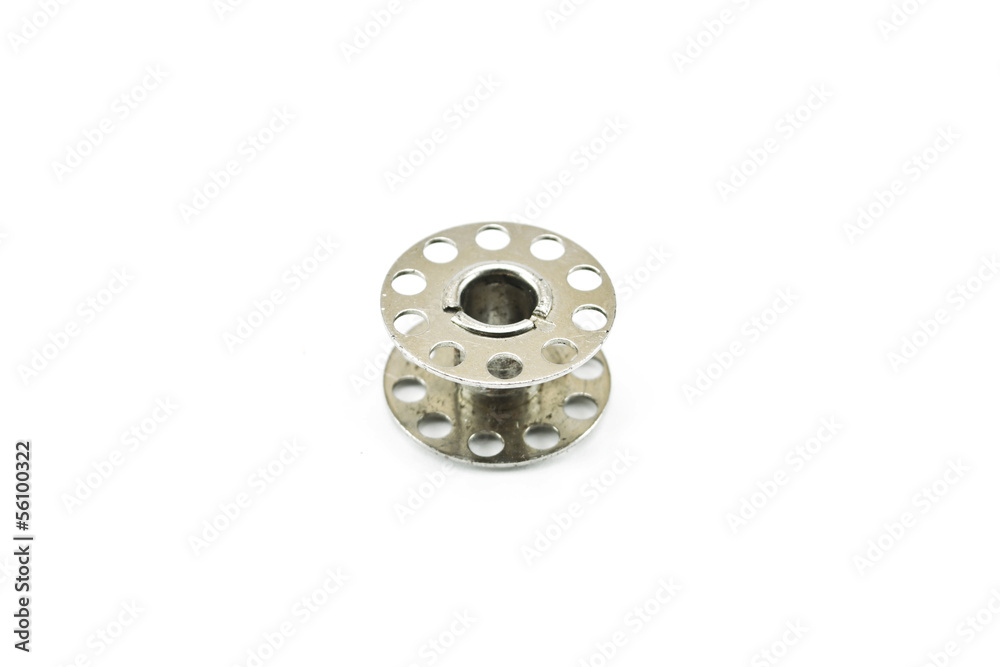Metal spools of thread on white background Metal spools of thread on white background