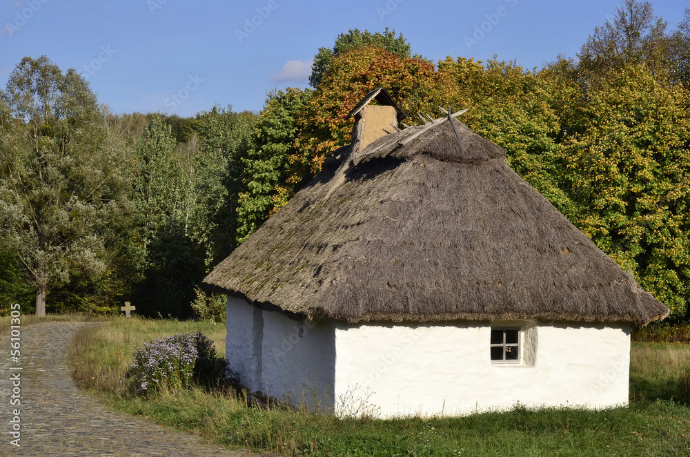 Old ukrainian house with a cross in the background