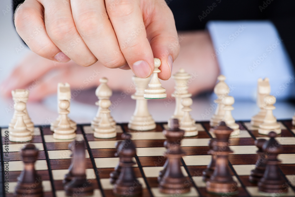 Mature businessman playing chess Mature businessman playing chess