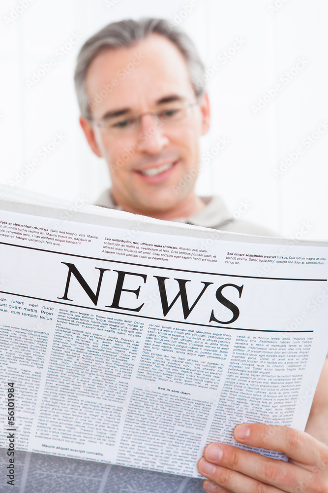 Naklejka premium Mature Man Reading Newspaper