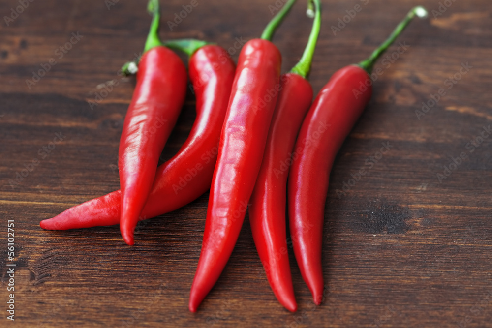 chili peppers on wood background