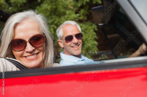 Side view of cheerful mature couple driving red cabriolet © WavebreakmediaMicro