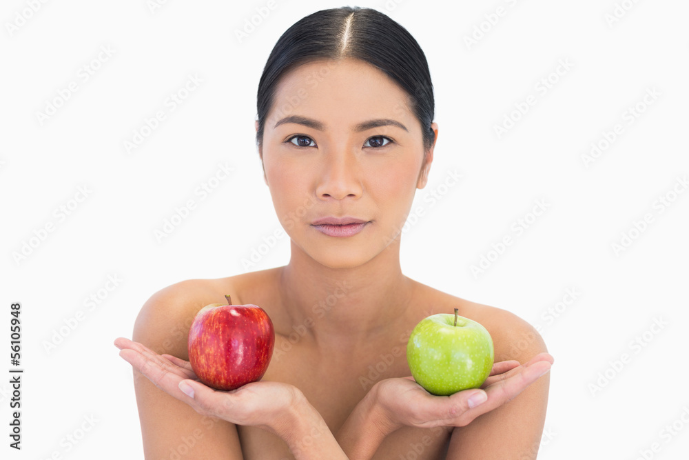 Natural brunette holding apples in both hands Natural brunette holding apples in both hands