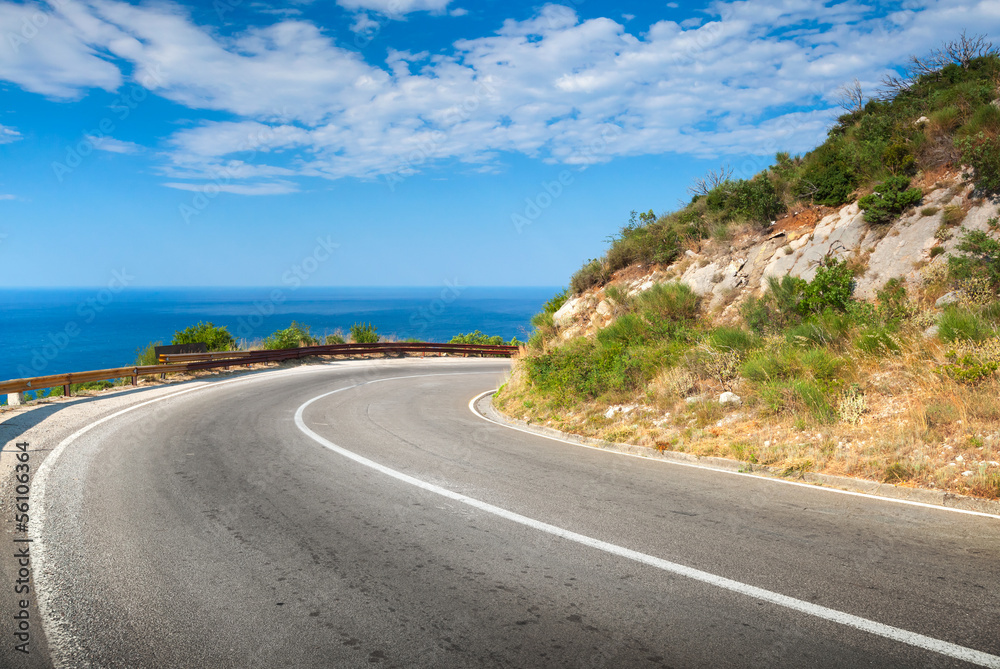 Turn of mountain asphalt road with sky and sea