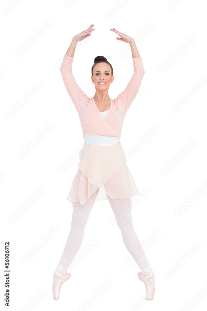 Smiling attractive ballerina standing on her tiptoes Smiling attractive ballerina standing on her tiptoes