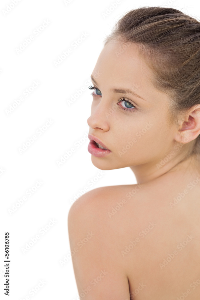 Thoughtful brunette model posing looking ober her shoulder Thoughtful brunette model posing looking ober her shoulder