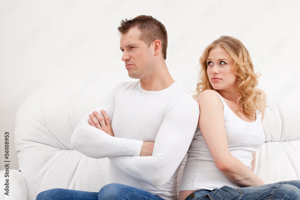 Young sad couple sitting