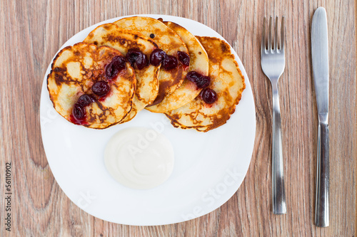 Delicious pancakes with cherry jam © Vankad