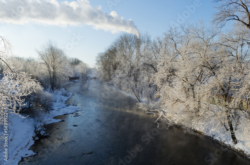 Landscape with the snow-covered trees near the river