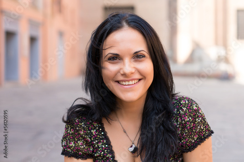smiling portrait of young woman in the old town
